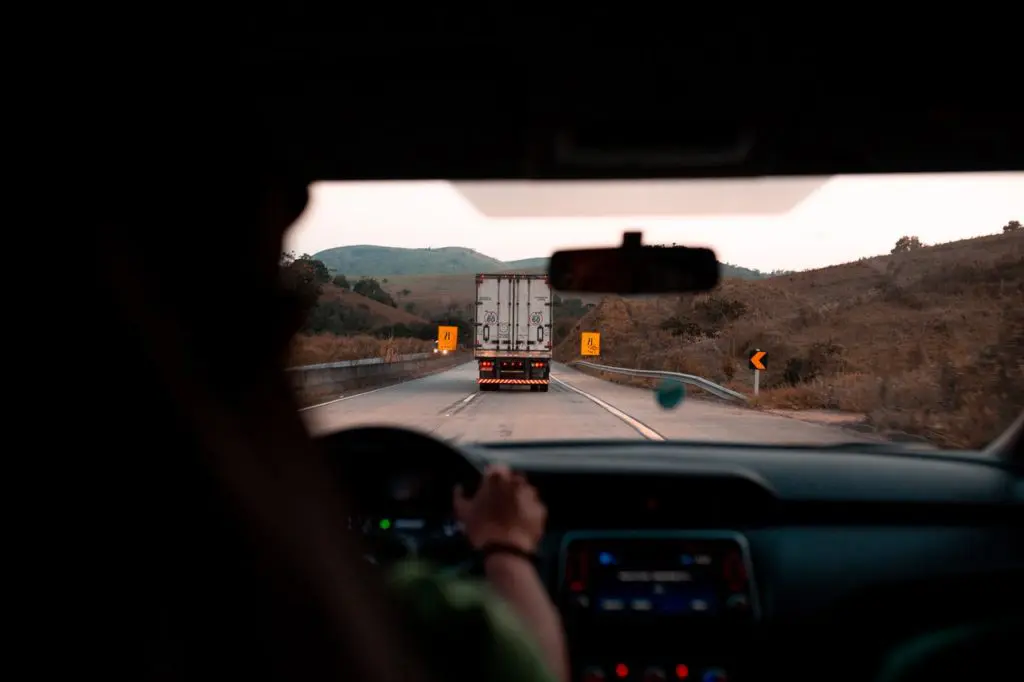 Car Driving Behind A Truck On Highway